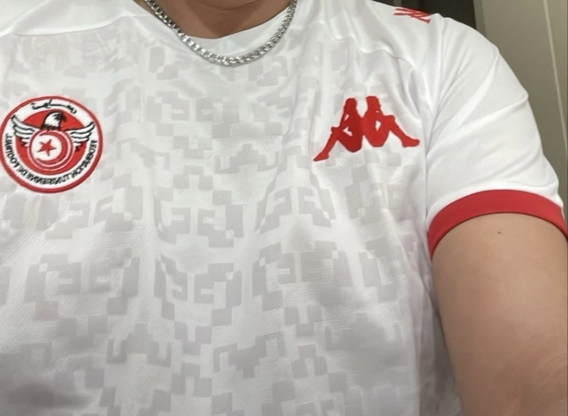 Tunisian World Cup Jersey showing a logo that, to this poster, looks like two nude women sitting back to back, in silhouette.